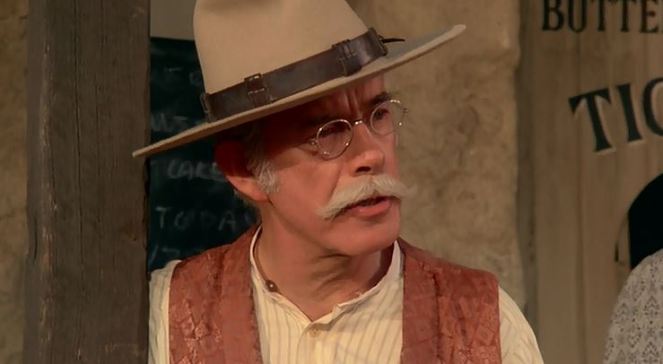 He's the local sheriff, local justice of the peace, AND the local barber! He's one up on Sheriff Andy Taylor!