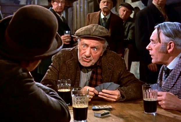 Let me rephrase that: he tells stories of leprechauns while attempting to play cards and drink what appears to be Coca-Cola!